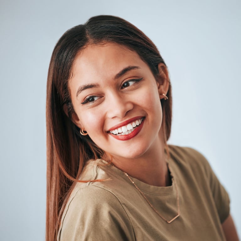 Woman displaying a transformed smile, highlighting smile makeover results
