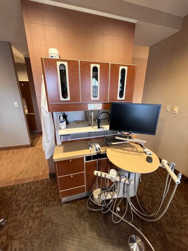Advanced dental equipment in a treatment room with brown walls