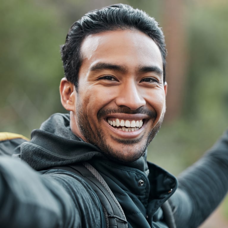 A man in a windbreaker smiling