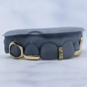 Custom gold gap filler grillz with open-face side caps and a pavé diamond accent bar, shown on a dental cast